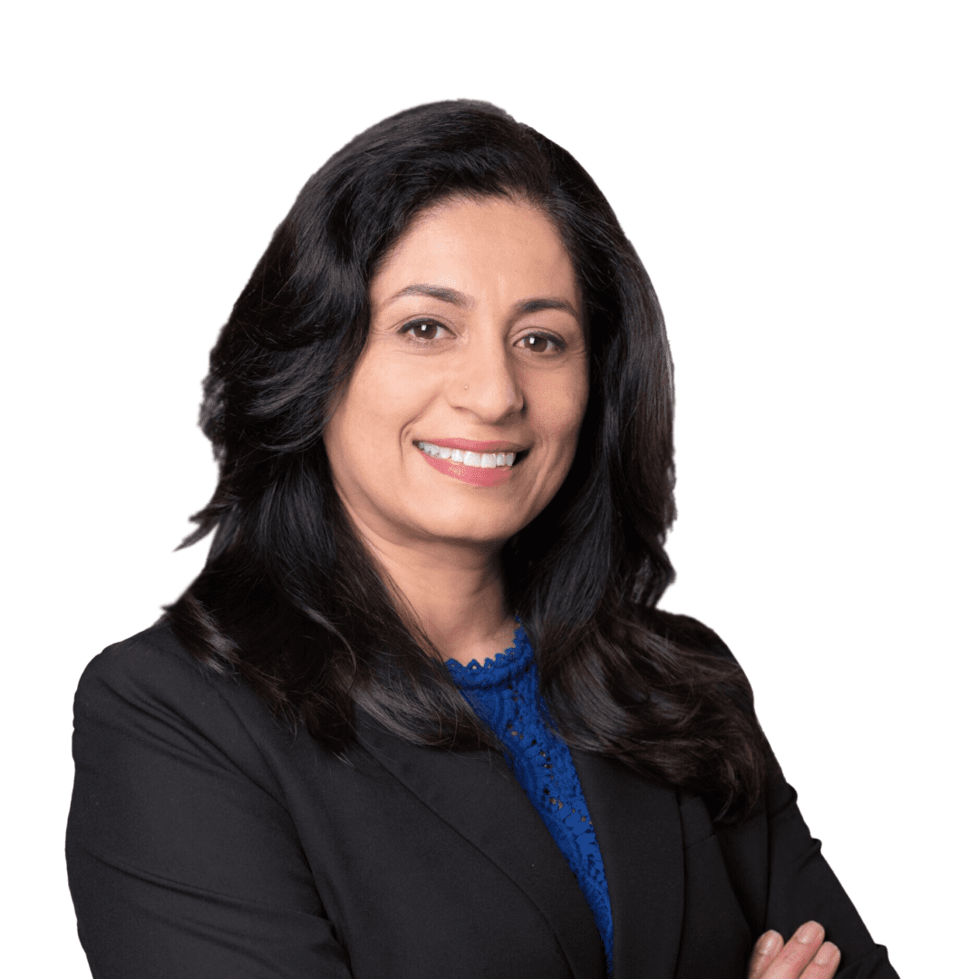 A woman in black jacket and blue shirt with arms crossed.