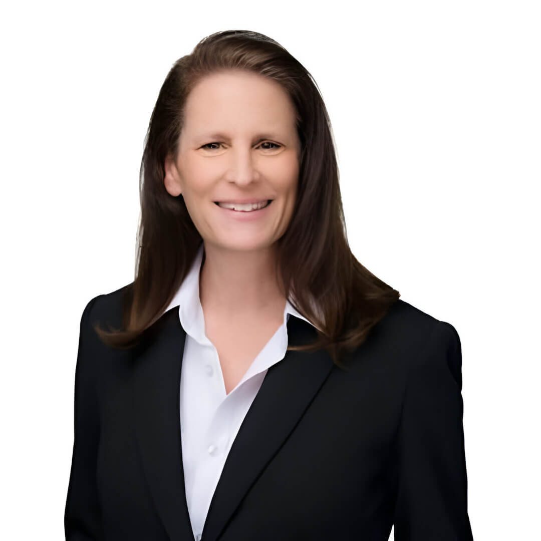 Smiling person in formal black suit.